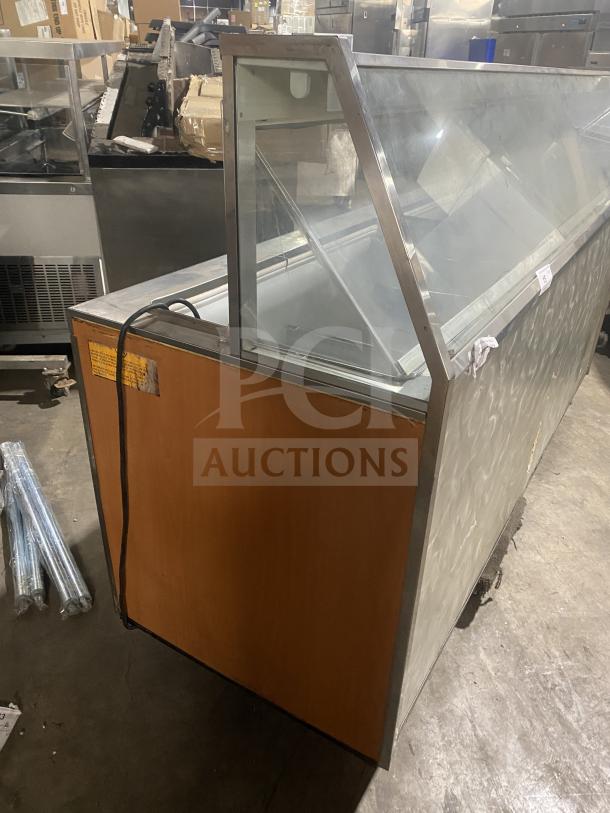 Commercial stainless steel dipping cabinet with slanted glass and rear lift-open access, ideal for ice cream or frozen yogurt.