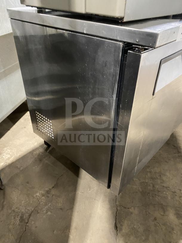 True TUC-72 stainless steel 3-door undercounter refrigerator, poly-coated racks, 115V, on casters, serial number 6718114.