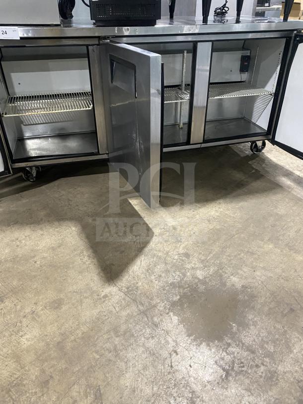 True TUC-72 3-door undercounter refrigerator with poly-coated racks, stainless steel, on casters, model SN: 6718114, 115V, 1 phase.