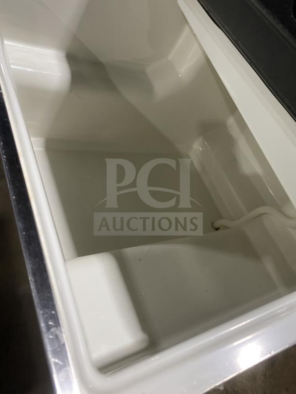 Hoshizaki KM231BAJ ice machine interior view, showing clean, spacious 80 lb. storage bin, stainless steel finish.