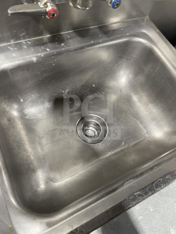 Jimex stainless steel wall-mount hand sink with backsplash, dual-handle faucet, commercial-grade, clean condition.