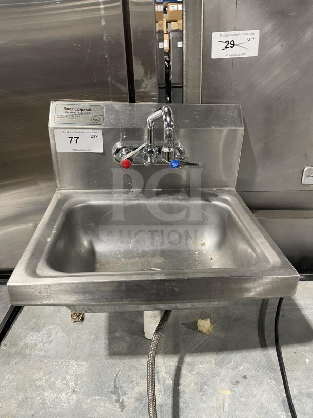 Jimex Corporation stainless steel wall-mount hand sink with back splash, dual handles, used condition, visible label.