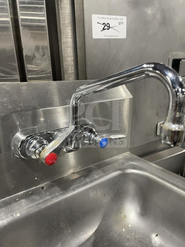 Jimex Corporation stainless steel wall-mount hand sink with backsplash, dual tap, slight wear, auction label visible.