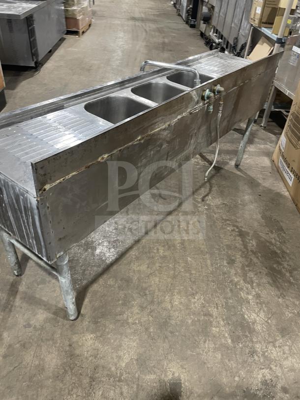 Jimex commercial 3-compartment stainless steel bar sink on legs, heavy-duty, visible wear, faucets attached, ideal for bars.