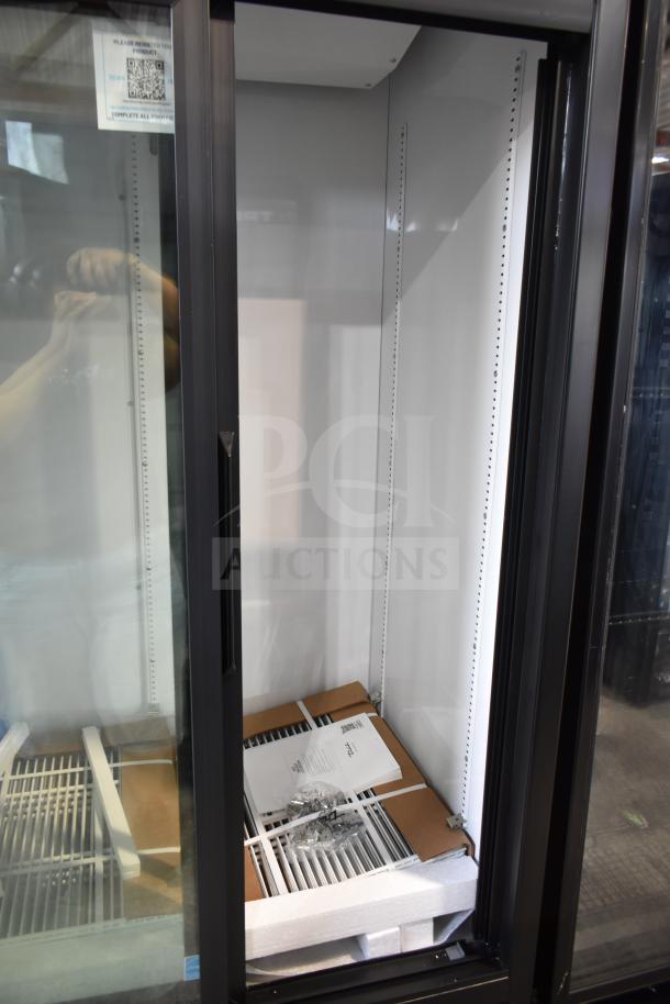 Brand new True GDM-33-HC-LD 2-door cooler merchandiser, 115V, 1 phase, tags indicating registration details, minor scratches.