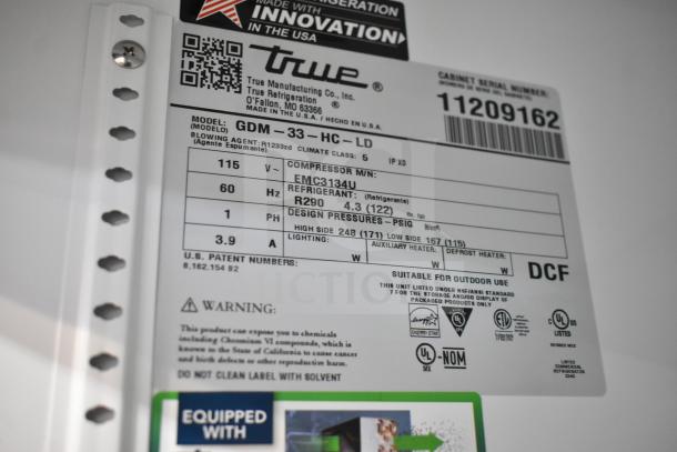 Label for True GDM-33-HC-LD cooler, showing model, voltage, refrigerant type, and safety certifications.