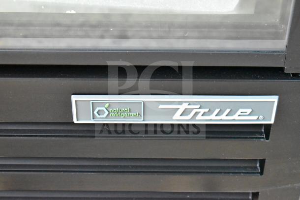 Alt text: True TVM-36SL-HC cooler merchandiser with "natural refrigerant" label, black exterior, brand new condition.