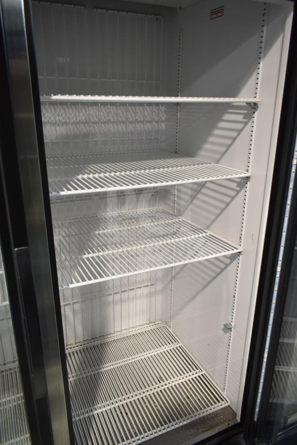 2020 True GDM-49F-HC commercial 2-door freezer, clean interior with shelves, tested and working, ideal for retail use.