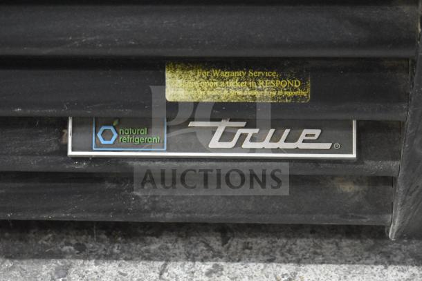 2020 True GDM-49F-HC commercial freezer label showing "True" logo and "natural refrigerant." Visible wear on the surface.