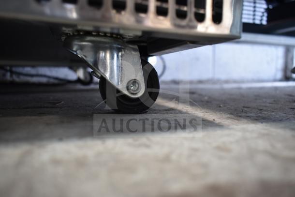 Close-up of a caster wheel on a 2025 Avantco 178SSCFT60HC 60" stainless steel refrigerated salad bar, showing its mobility feature.