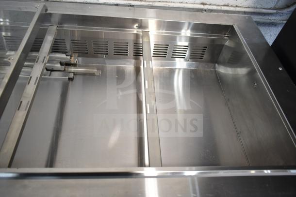 Avantco 178SSCFT60HC 60" stainless steel refrigerated salad bar, brand new with scratch and dent, on commercial casters.