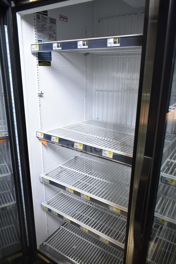 True GDM-72F-HC commercial freezer, 3-door, white interior, wire shelving, tested and working, 115/208-230V, labels visible.
