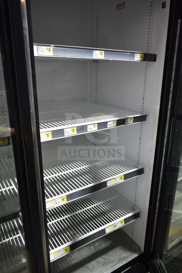 2017 True GDM-72-HC commercial cooler with three glass doors, adjustable shelves, and visible price labels. Tested and working.