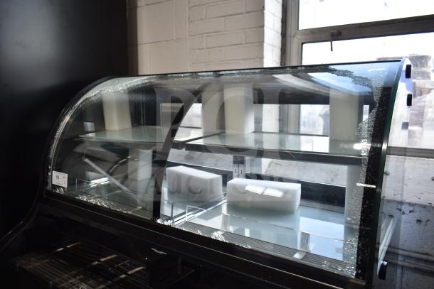 Avantco 178GDC40HCB black refrigerated merchandiser with curved dual service air curtain. Glass damage visible. 115 volts, 1 phase.