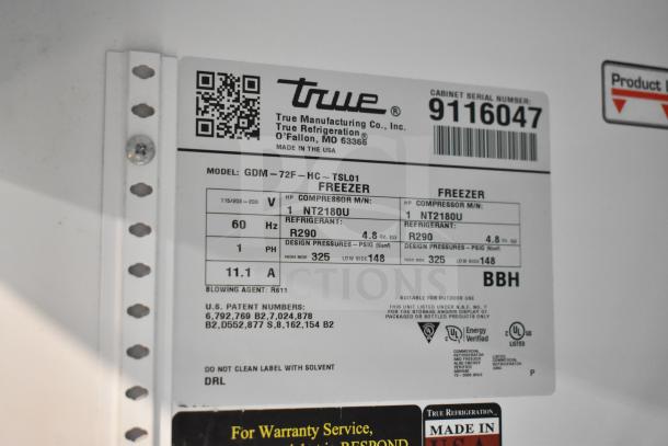 2017 True GDM-72F-HC, commercial 3-door reach-in freezer merchandiser, label showing voltage and refrigerant info.