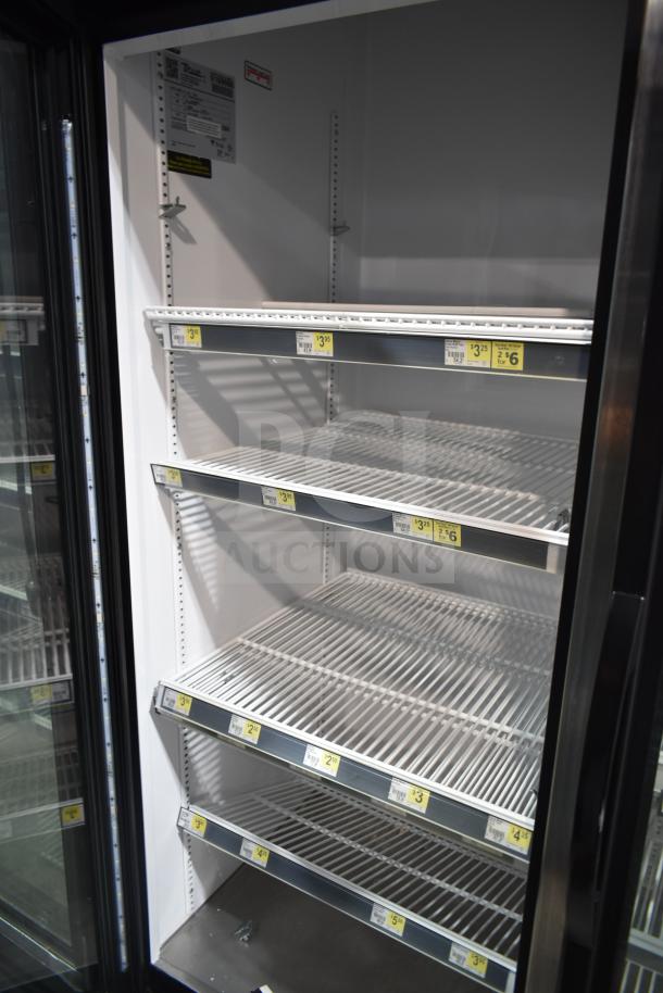 2017 True GDM-72-HC 3-door reach-in cooler with metal shelving, price tags, and model label. 115V, tested and working.