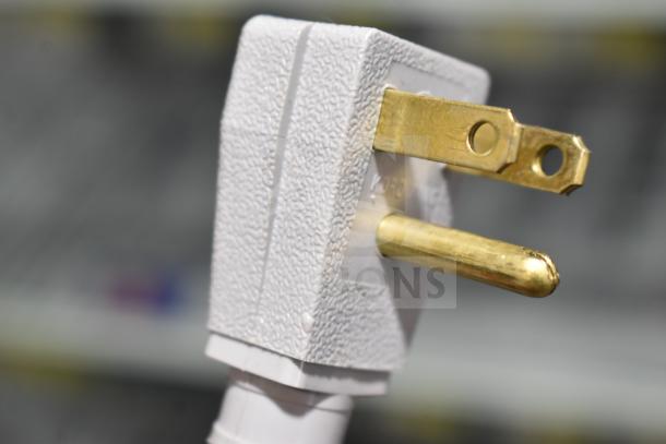 Close-up of a three-prong plug for a True GDM-49-HC cooler merchandiser, showing textured white casing and brass prongs.