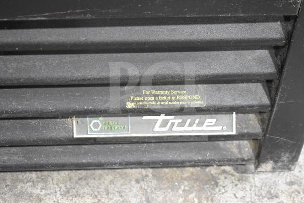 2017 True GDM-72F-HC 3 Door Reach In Freezer, tested and working. Natural refrigerant, warranty service notice visible.