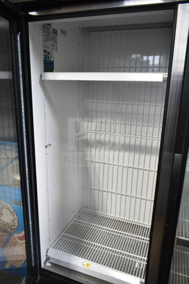 2021 True GDM-49F-HC commercial freezer, 2-door, tested working, 115/208-230V, 1 phase, interior label with specs visible.