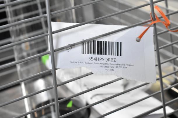 Brand new Backyard Pro Courtyard HPSQRBZ bronze patio heater, 40,000 BTU, with glass tube; barcode tag visible.