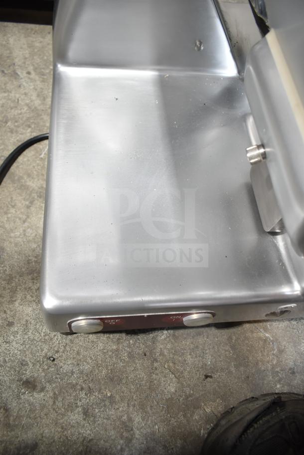 Brand new Estella 348SLM13 13" heavy-duty manual meat slicer with blade sharpener. Features on/off buttons.