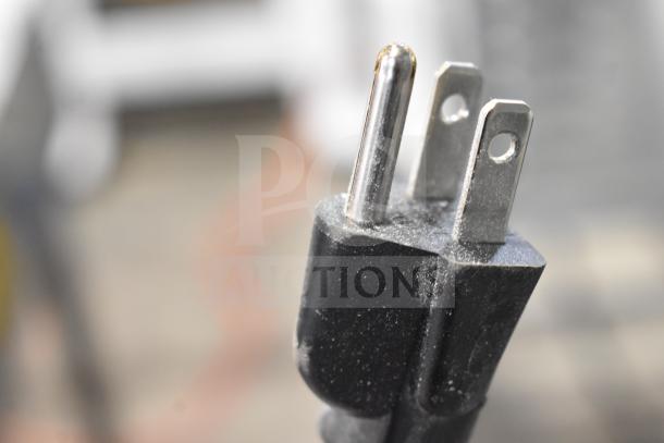 Close-up of a power plug for the Estella 348SLM13 manual meat slicer, 115 volts, showing three prongs.