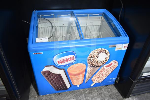 AHT RIO S 100 commercial ice cream freezer, blue with Nestle graphics, glass top, 110-120 volts, tested and working.
