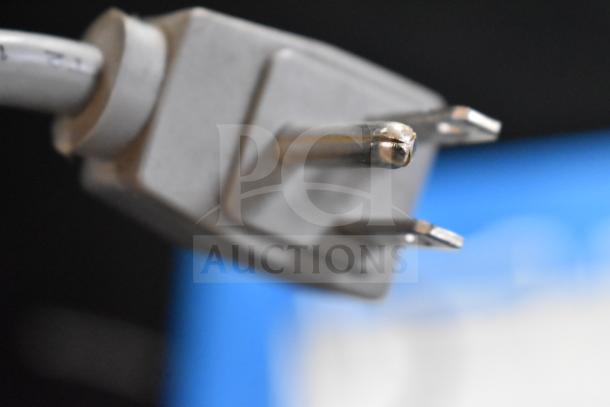 Close-up of a power plug for the AHT RIO S 100 Commercial Ice Cream Freezer Merchandiser, showing two prongs.