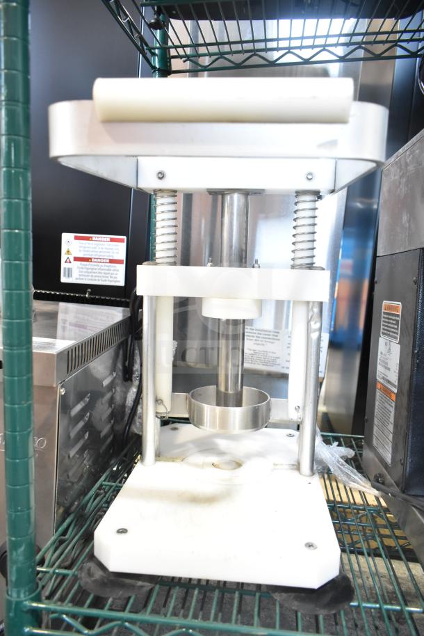 Countertop Pineapple Corer in good condition, featuring a sturdy metal frame and circular coring component.