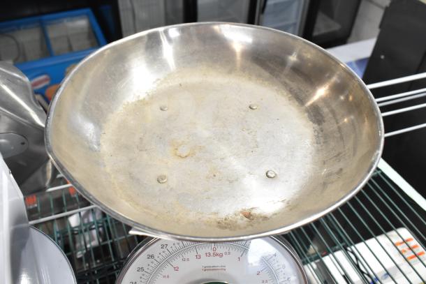 Detecto T25BN scale with large stainless steel weighing pan, visible weight markings, on metal rack. Used condition.