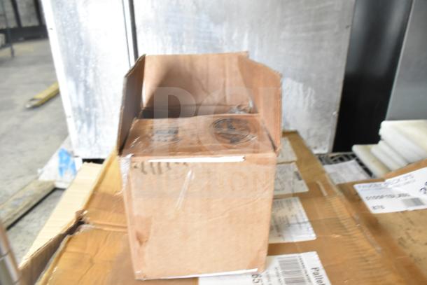 Cardboard box on pallet, labeled for shipping. Contains CHNT CJX2-18 items, scratch and dent, 9922817960 trays.