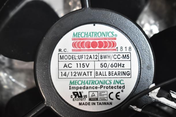 Mechatronics fan model UF12A12, AC 115V, 14/12W, ball bearing, impedance-protected, made in Taiwan, brand label shown.