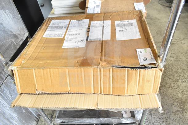 Cardboard box with labels containing brand new, scratch and dent items: 9922817960 trays and CHNT CJX2-18 with CHNT GB/T 14048.5.