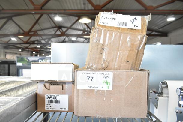 Four boxes, labeled and partially open, on a metal shelf. Items include thermocouple, control board, and pilot assembly. New with minor dents.