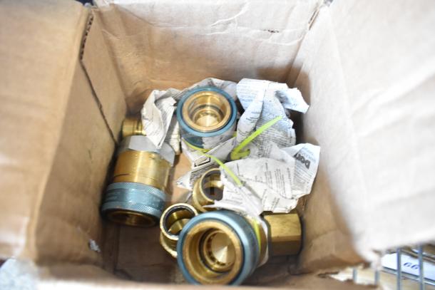 Box of four new scratch and dent items, including brass fittings wrapped in paper. Components appear to be thermocouple parts.