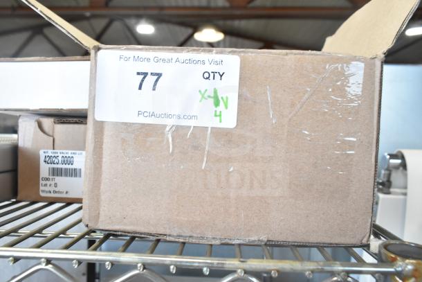 Cardboard box with PCI Auctions label showing lot number 77, containing new scratch and dent items like a thermocouple and control board.