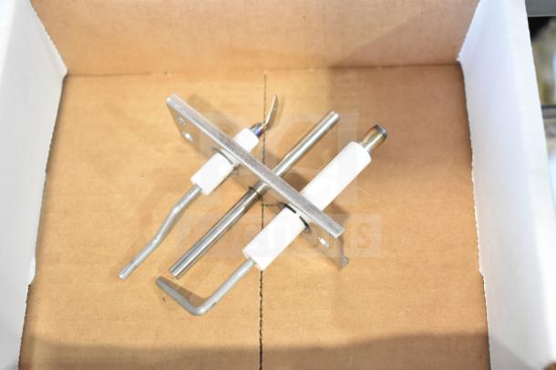 Boxed pilot assembly, new scratch and dent condition, featuring metal rods and ceramic insulation.