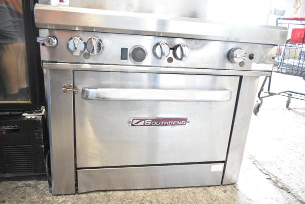Southbend commercial gas 6-burner range with oven, stainless steel, used condition, visible Southbend logo.