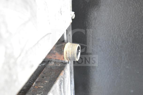 Southbend Commercial Gas Range connection detail, showing gas line fitting on a 6 burner oven with backsplash. Condition shows wear.