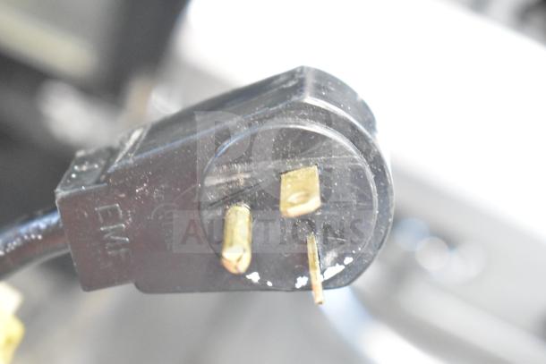 Close-up of a power plug for the Master-Bilt BLG-48-HGP Commercial Reach-In Freezer, 115/208-230 Volts, 1 Phase.