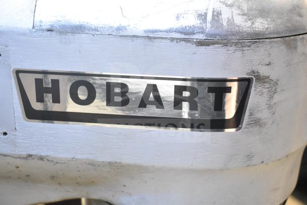 Hobart A200 commercial dough mixer logo on metal surface, highlighting brand.