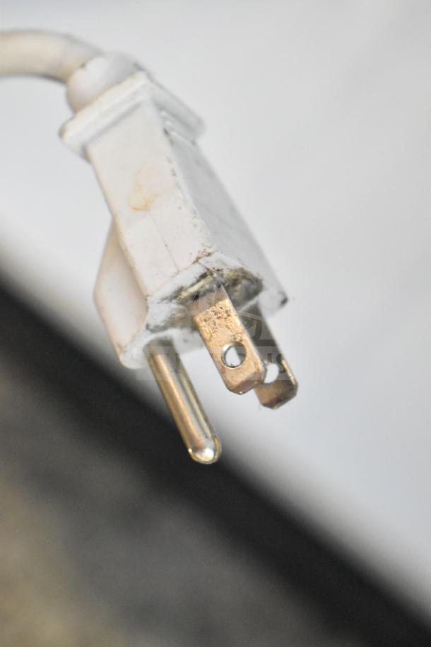 Close-up of a three-prong electrical plug for the Atlantic USS 374 DTKL commercial cooler, 115 volts, single phase.