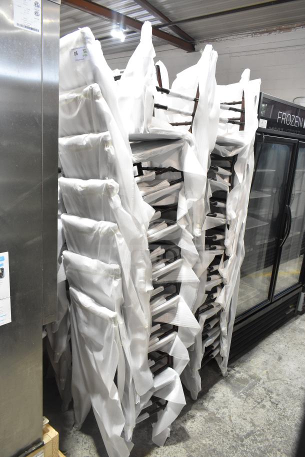 32 Flash Furniture XS-WALNUT-GG Hercules Walnut Chiavari chairs, stacked, wrapped in protective covers, new condition.