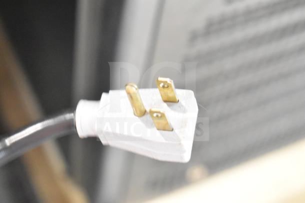 Close-up of a three-prong plug for the True GDM-41SL-48-HC-LD cooler, showing electrical compatibility.