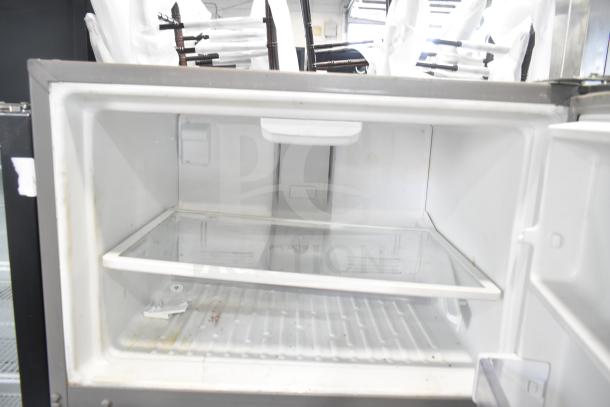 2016 Whirlpool WRT511SZDM00 reach-in cooler with freezer, 115 volts, 1 phase. Visible interior shelves. Used condition.