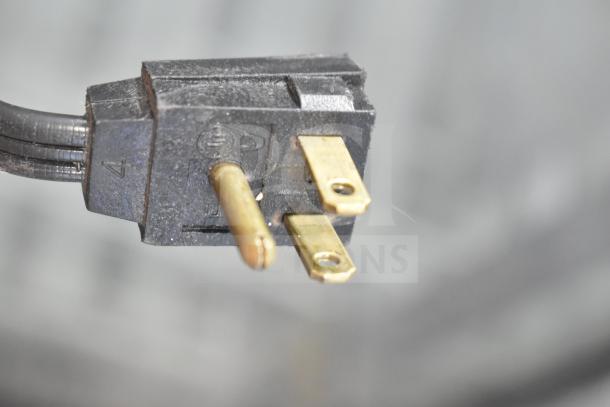 Close-up view of a three-pronged plug for the 2016 Whirlpool WRT511SZDM00 reach-in cooler, 115 volts, 1 phase.