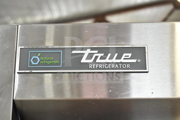 2022 True T-35-HC Commercial Cooler, stainless steel, 2 doors, with natural refrigerant label and logo, on casters.