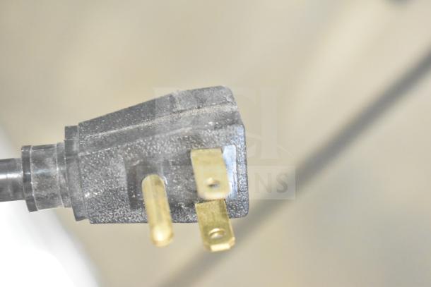 Close-up of a power plug for the 2021 True T-35-HC Commercial 2 Door Reach In Cooler, shown on commercial casters.