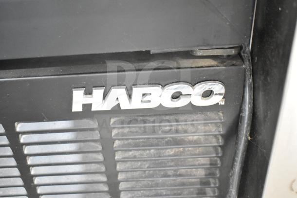Habco SE12 Cooler Merchandiser logo on black surface, showcasing brand detail of commercial fridge. 115 Volts, 1 Phase.
