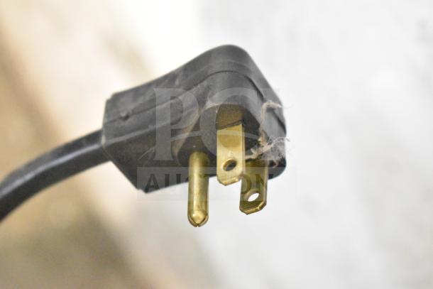 Close-up image of a 115-volt power plug for Habco ESM10 cooler, showing three prongs, slightly dusty.
